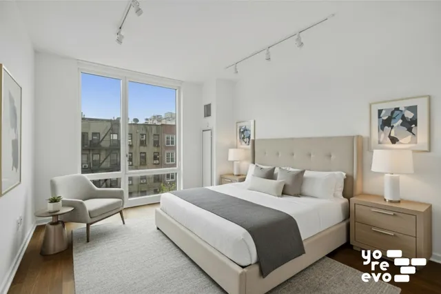 a bedroom with a large bed and a window