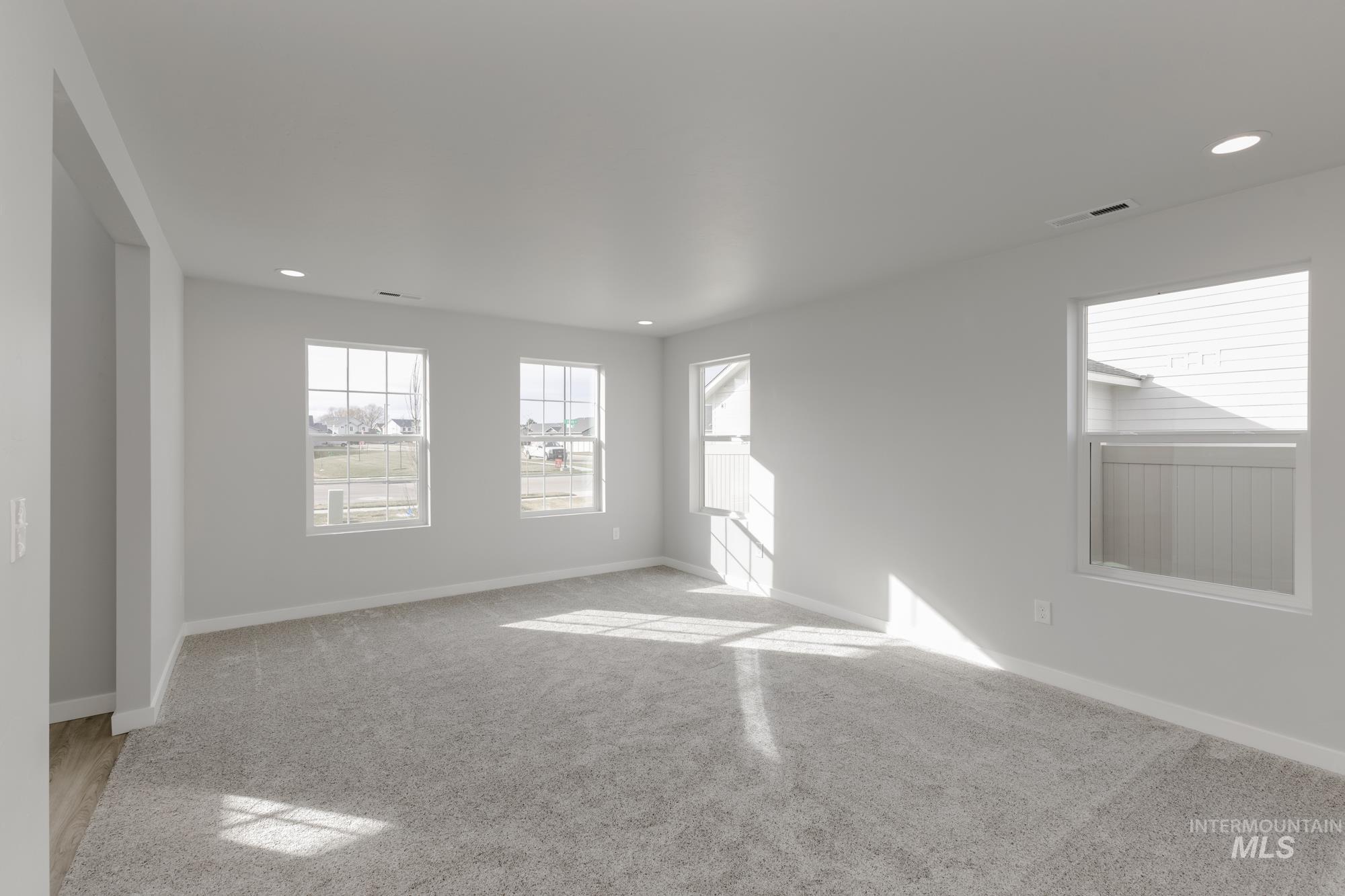 13683 Higley Court Caldwell, ID 83607 - Photo 13 of 31 Spare room featuring plenty of natural light, recessed lighting, and light colored carpet