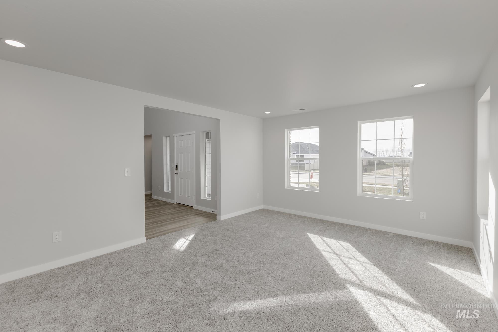 13683 Higley Court Caldwell, ID 83607 - Photo 14 of 31 Empty room with recessed lighting and light carpet