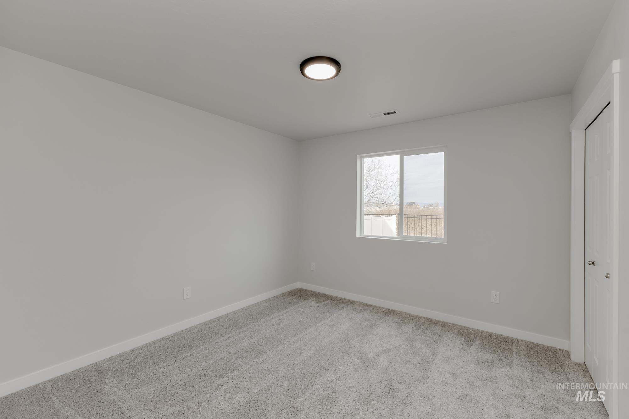 13683 Higley Court Caldwell, ID 83607 - Photo 17 of 31 Unfurnished bedroom featuring light colored carpet and a closet