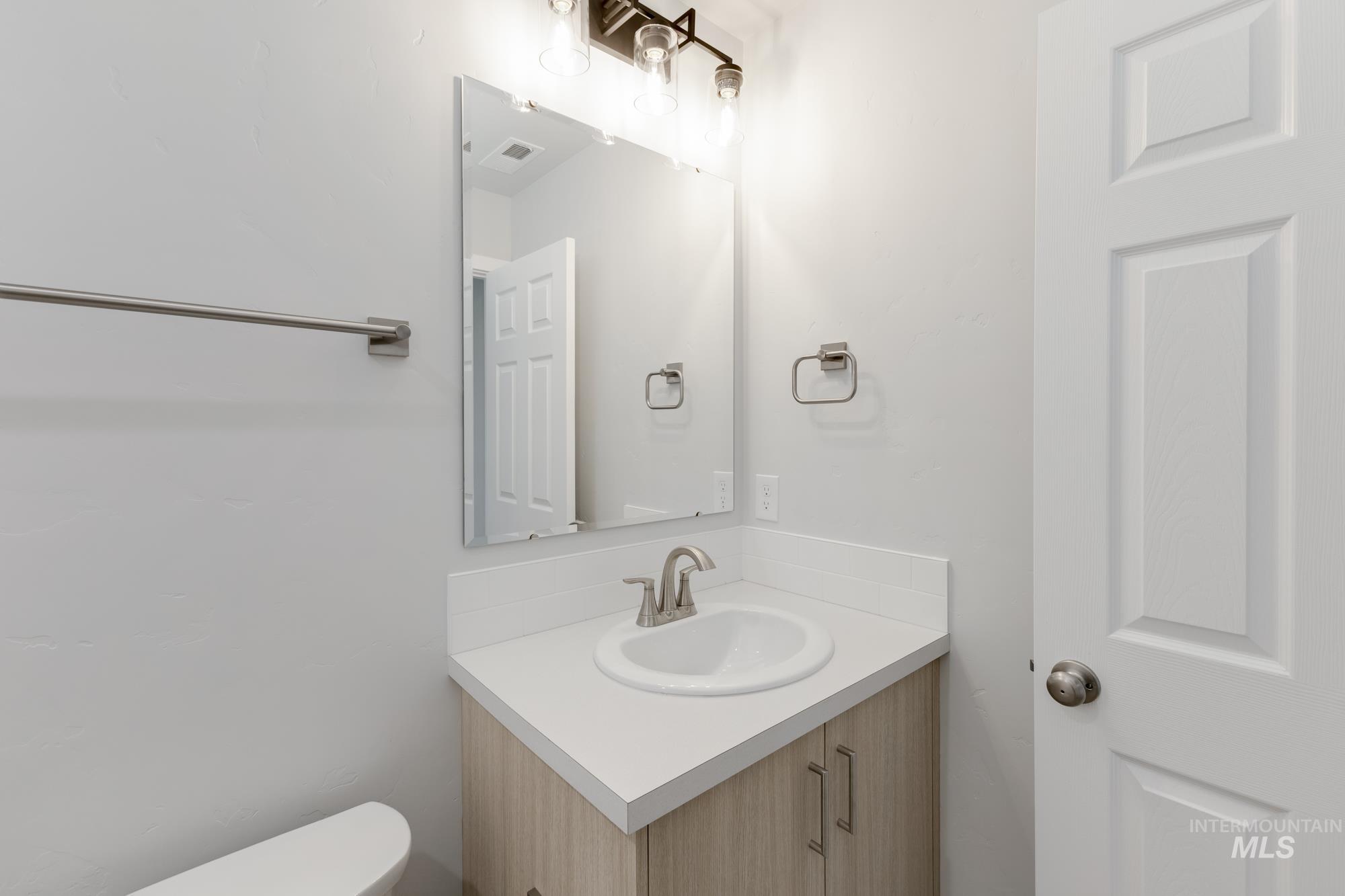13683 Higley Court Caldwell, ID 83607 - Photo 18 of 31 Half bath featuring vanity and toilet