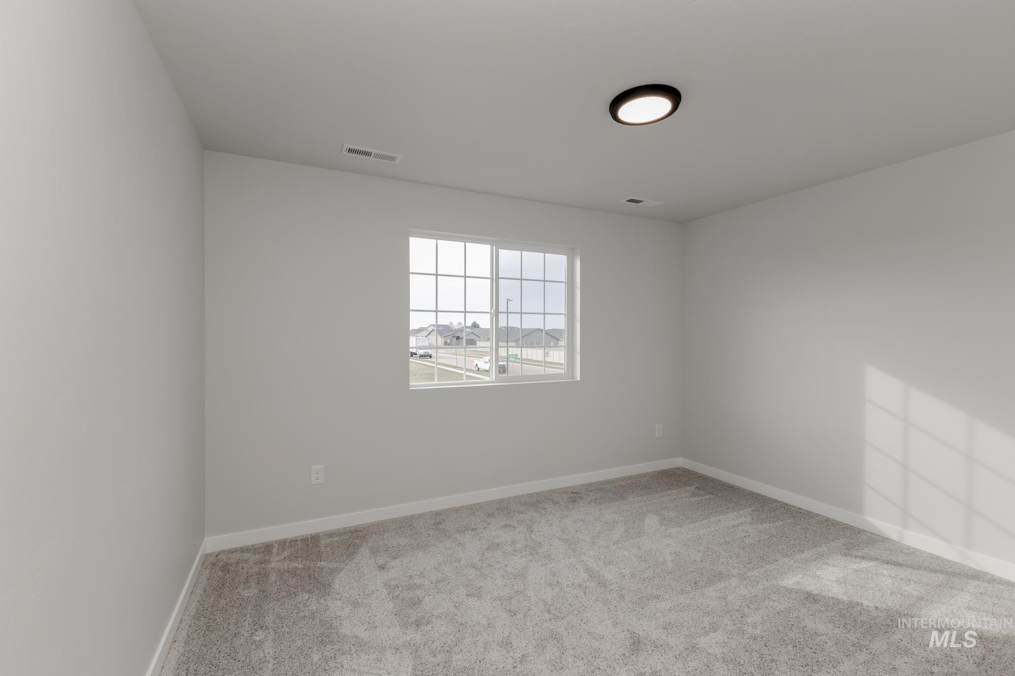 13683 Higley Court Caldwell, ID 83607 - Photo 23 of 31 Empty room with light carpet and baseboards