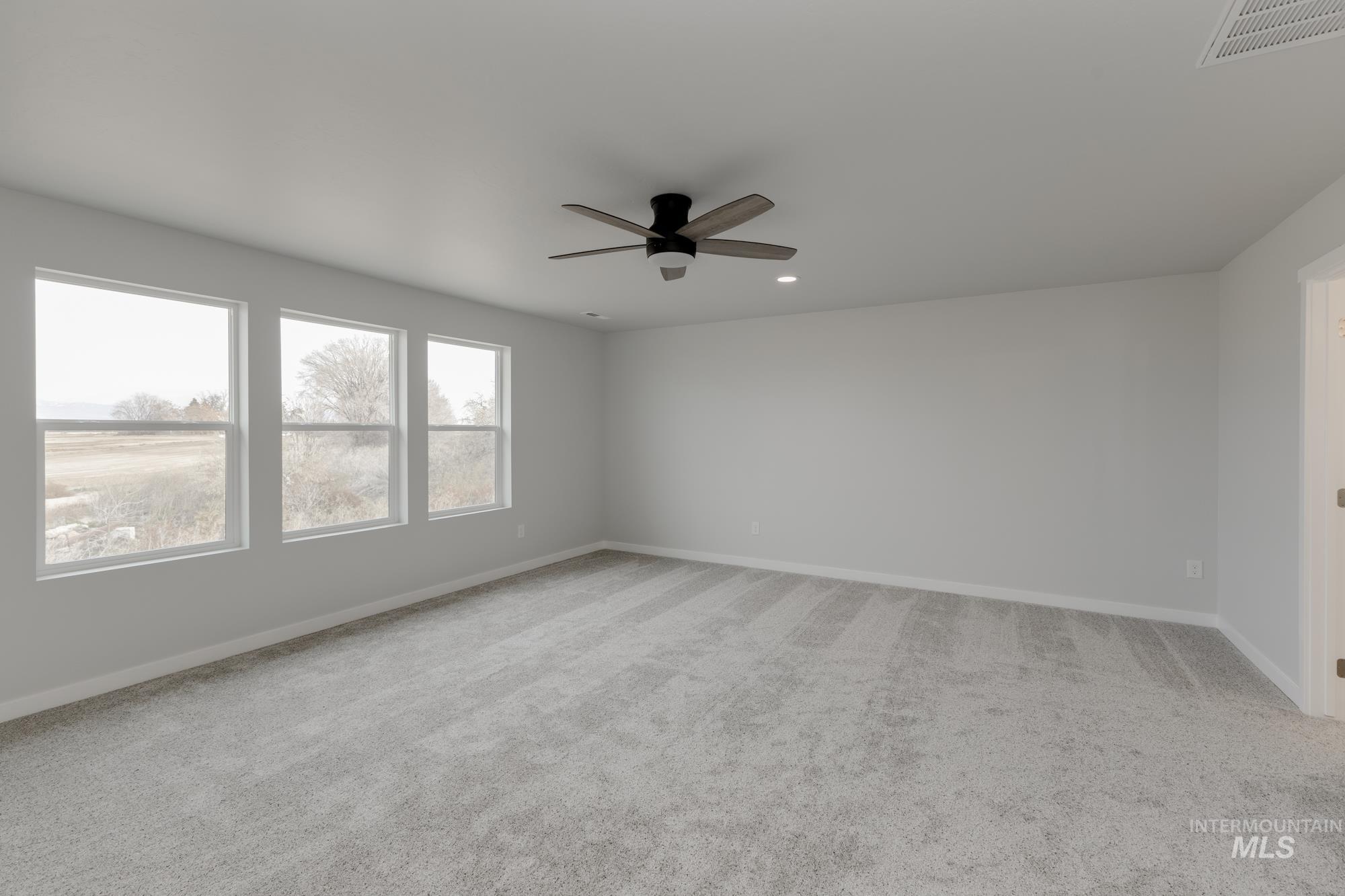 13683 Higley Court Caldwell, ID 83607 - Photo 26 of 31 Spare room with light carpet, a ceiling fan, and recessed lighting