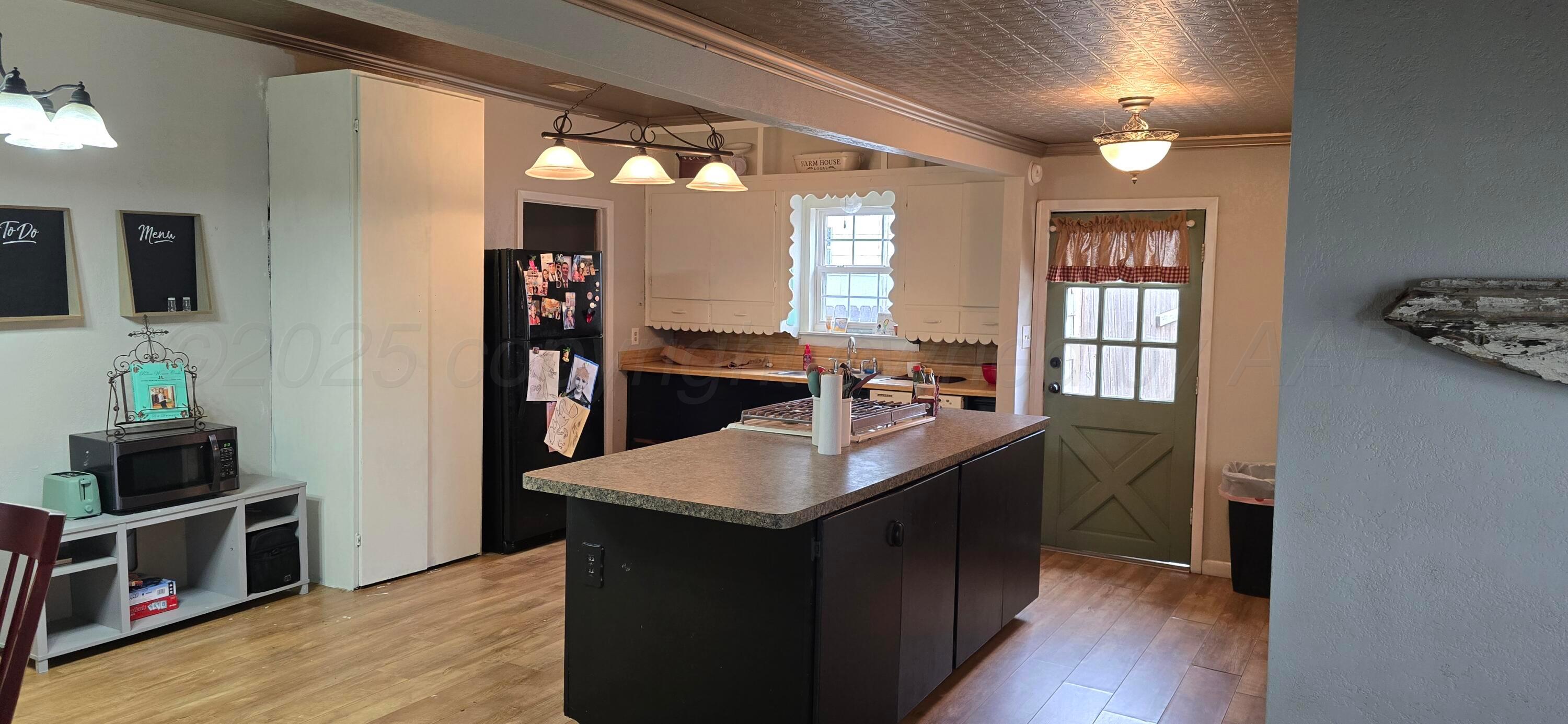 2115 Hemlock Street Borger, TX 79007 - Photo 11 of 43 a kitchen with kitchen island granite countertop a sink stove and refrigerator