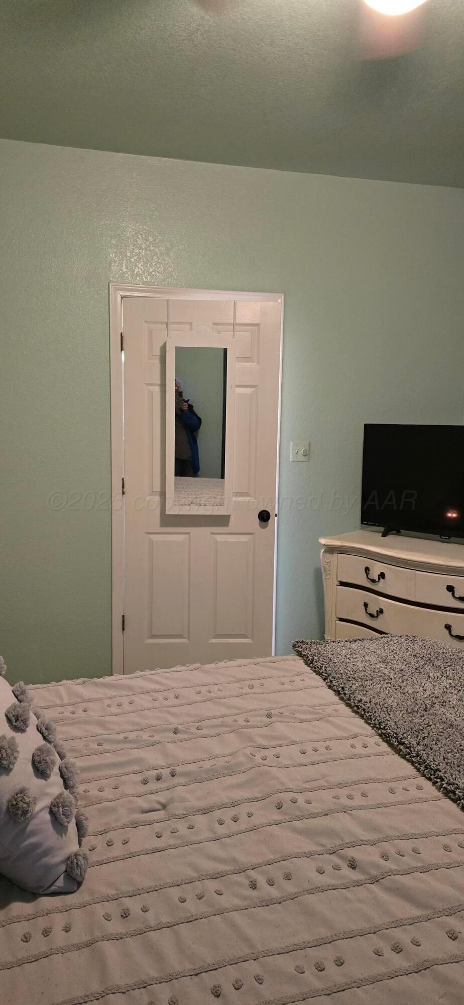 2115 Hemlock Street Borger, TX 79007 - Photo 16 of 43 a bedroom with a bed and a flat screen tv