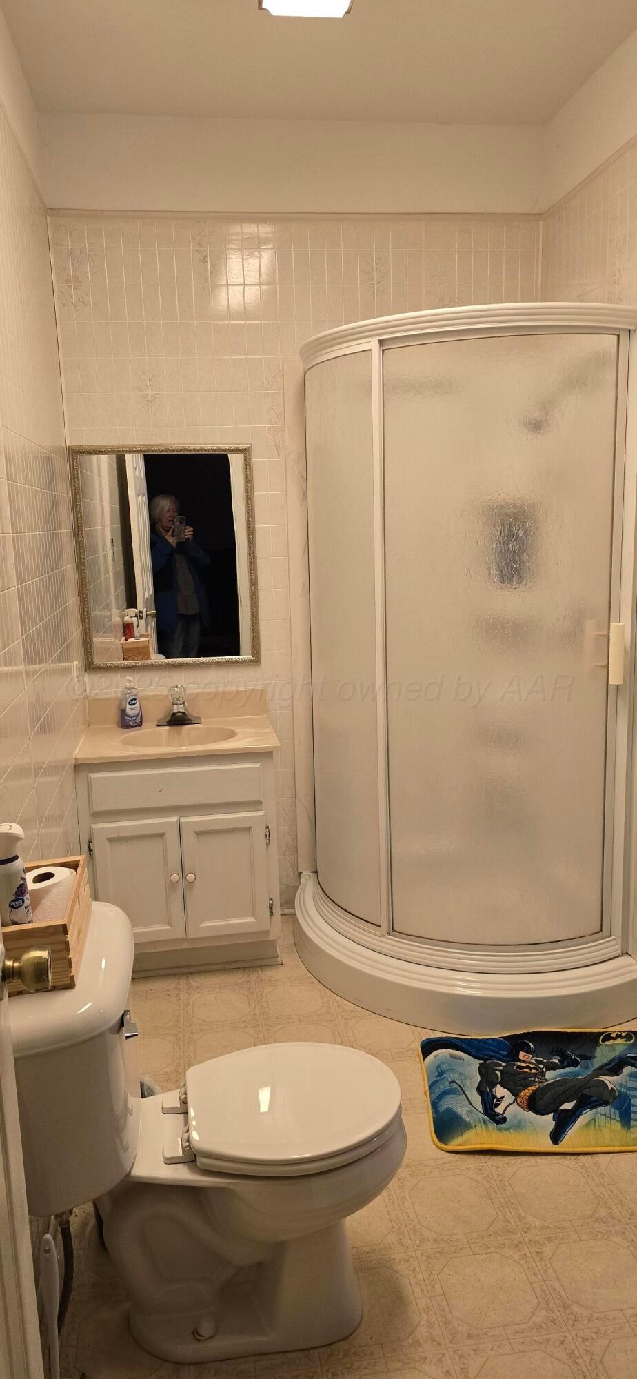 2115 Hemlock Street Borger, TX 79007 - Photo 26 of 43 a bathroom with a sink a toilet and shower