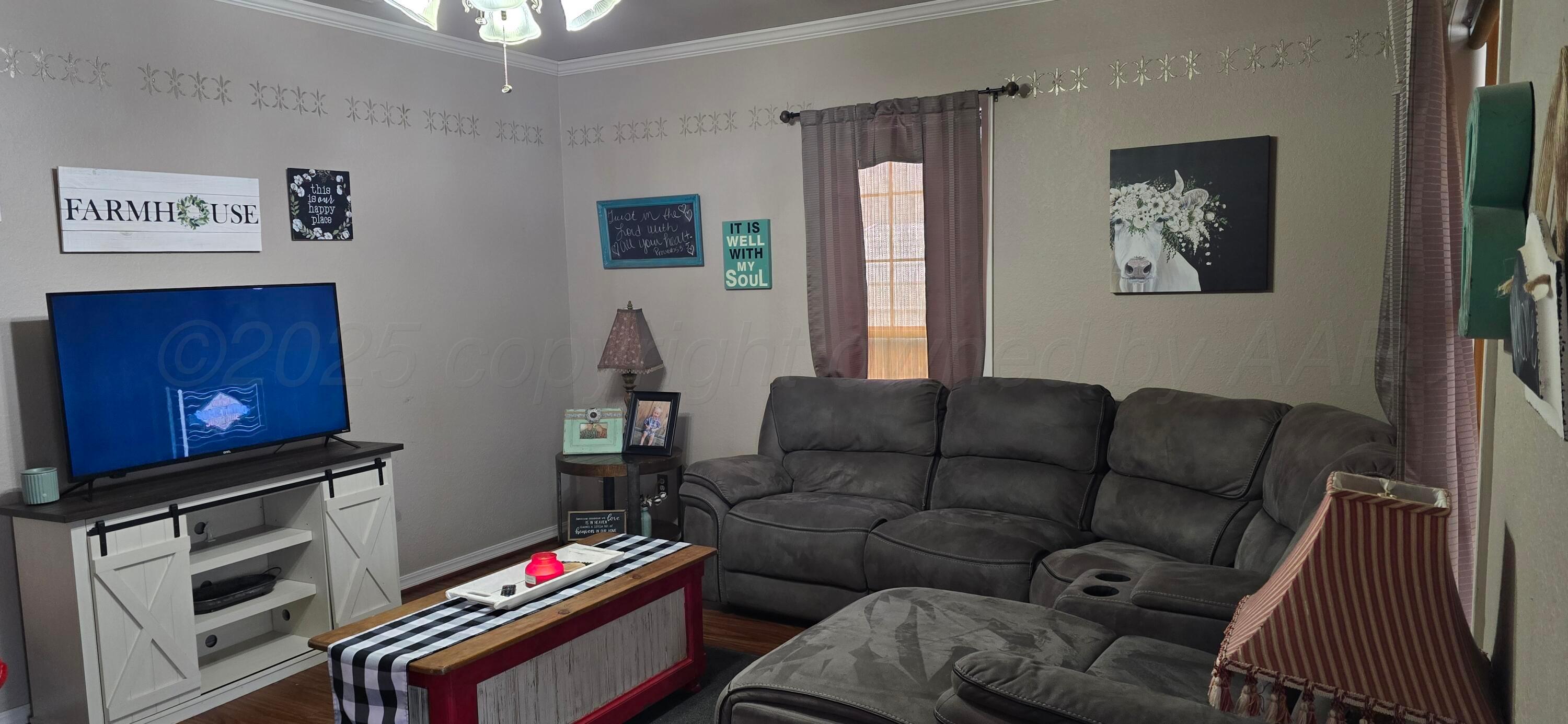 2115 Hemlock Street Borger, TX 79007 - Photo 4 of 43 a living room with furniture a piano and a flat screen tv