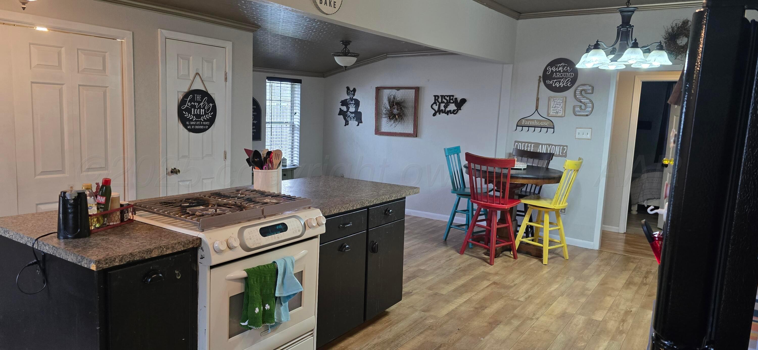 2115 Hemlock Street Borger, TX 79007 - Photo 10 of 43 a kitchen with stainless steel appliances granite countertop a stove and a wooden cabinets