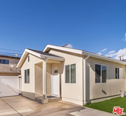 a view of a white house with a outdoor space