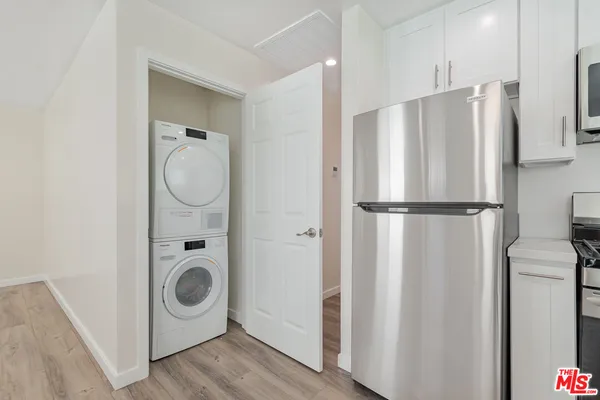 a kitchen with refrigerator a washer and dryer