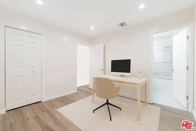 a work room with furniture and wooden floor