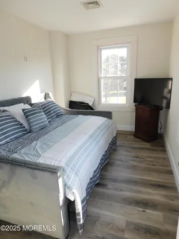 a bedroom with bed and window