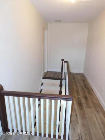 a view of staircase with rug