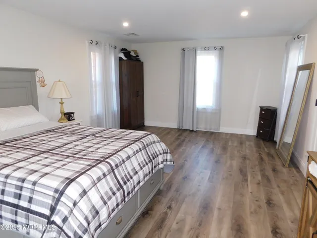 a bedroom with a bed and a large mirror