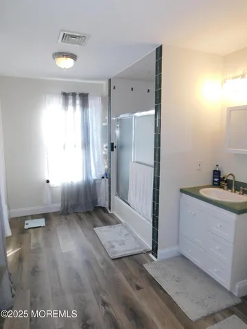 a view of hallway with a sink and a large window