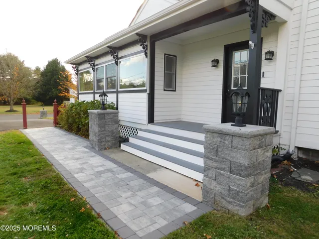 a view of a patio with table and chairs and potted plants
