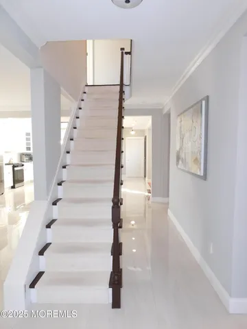 a view of entryway and hall with wooden floor