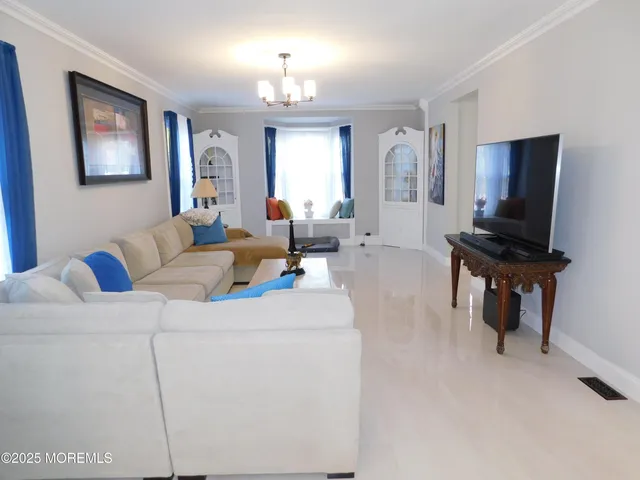 a living room with furniture a large window and a flat screen tv