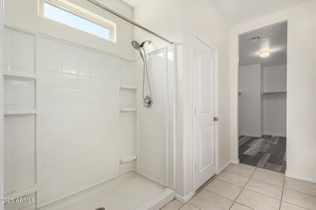 a bathroom with a shower and a sink