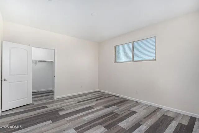 a view of a room with wooden floor and closet