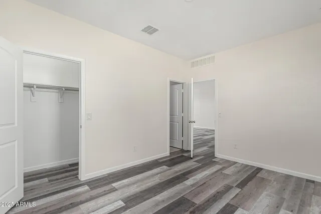 a view of a room with wooden floor and white doors