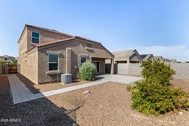 a front view of a house with a yard and outdoor seating