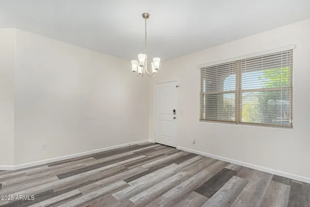 a view of a room that has a window and wooden floor