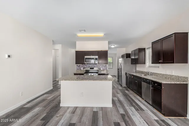 a kitchen with stainless steel appliances granite countertop a stove and a sink