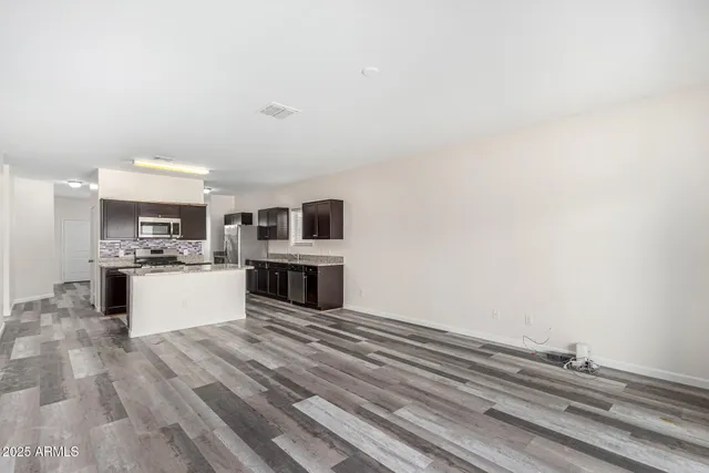 a view of kitchen with microwave oven stove and oven