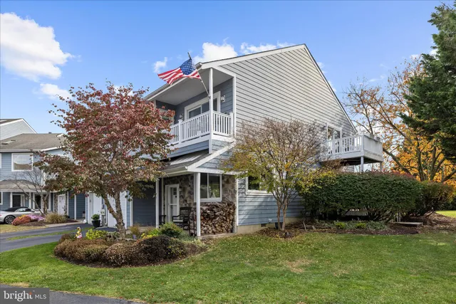 a dining room with furniture potted plants and wooden floor