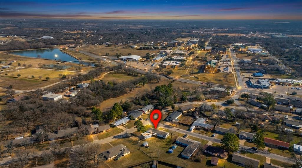 100 Rosedale Avenue Keene, TX 76059 - Photo 22 of 22 Aerial perspective showcasing a residential neighborhood with tree-lined streets and a nearby body of water