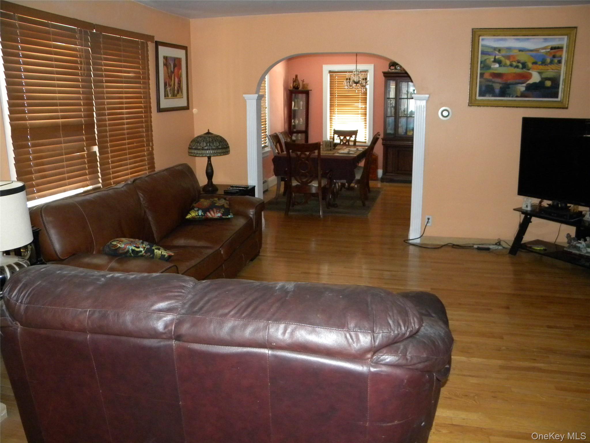 241-26 86th Road Queens, NY 11426 - Photo 5 of 38 a living room with furniture and a flat screen tv