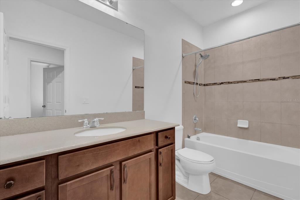 9084 Shepton Street Orlando, FL 32825 - Photo 20 of 26 a bathroom with a sink a toilet and shower