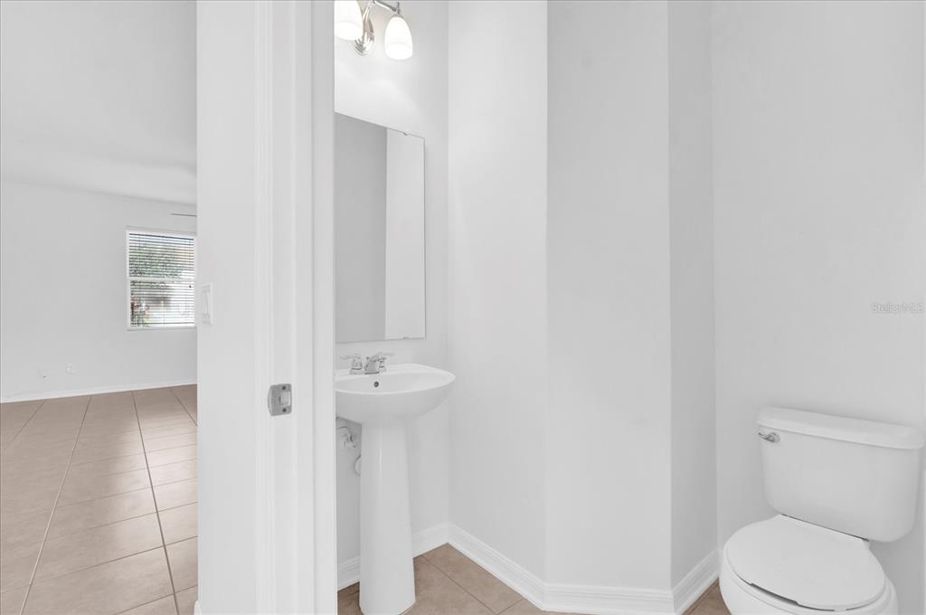 9084 Shepton Street Orlando, FL 32825 - Photo 21 of 26 a white toilet sitting next to a shower