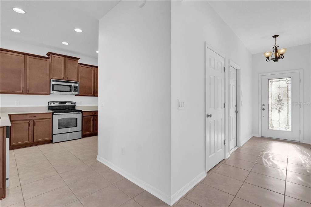 9084 Shepton Street Orlando, FL 32825 - Photo 3 of 26 a kitchen with stainless steel appliances a refrigerator and a stove top oven