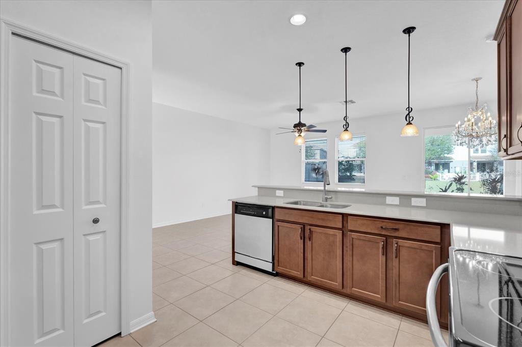 9084 Shepton Street Orlando, FL 32825 - Photo 5 of 26 a view of a kitchen with kitchen island granite countertop lots of counter top space and cabinets