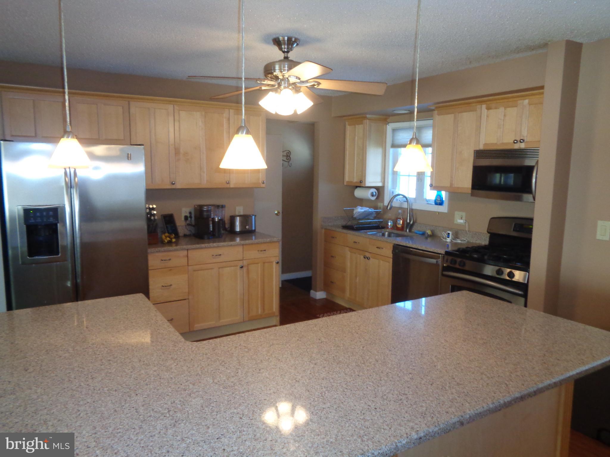 2380 Klockner Road Hamilton, NJ 08690 - Photo 4 of 21 a kitchen with stainless steel appliances granite countertop a sink a stove and refrigerator
