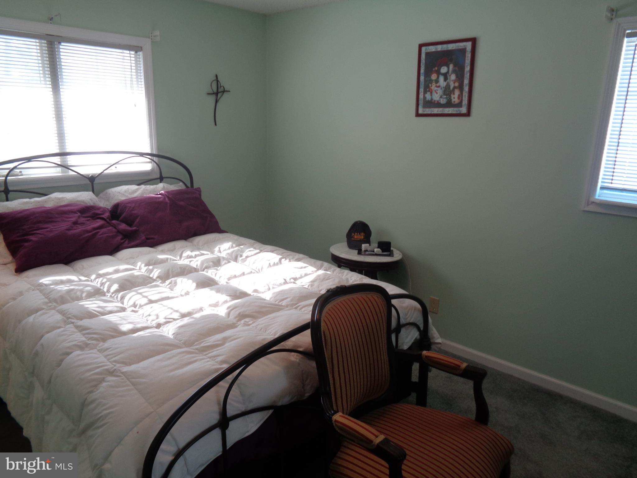 2380 Klockner Road Hamilton, NJ 08690 - Photo 8 of 21 a bed sitting in a bedroom next to a window