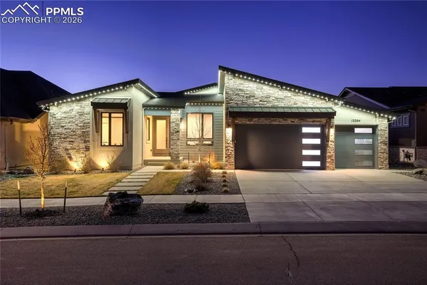 a bedroom with a bed and large windows