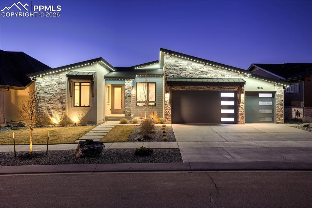 12284 Monarchos Lane Colorado Springs, CO 80921 - Photo 1 of 50 a bedroom with a bed and large windows