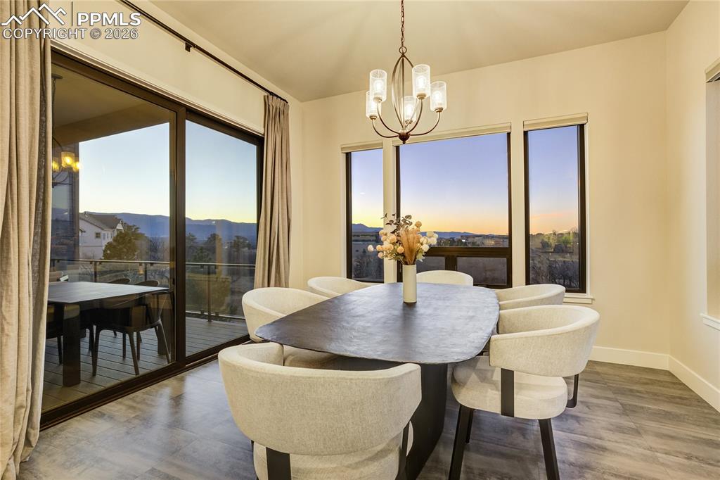 12284 Monarchos Lane Colorado Springs, CO 80921 - Photo 11 of 50 a view of a dining room with furniture window and wooden floor