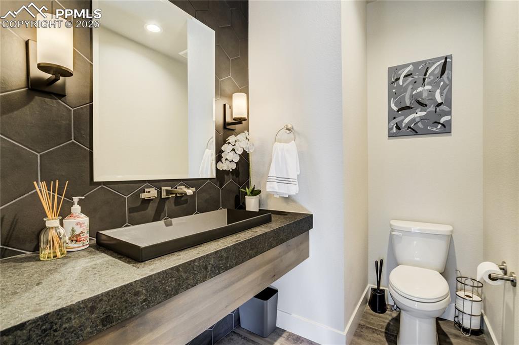12284 Monarchos Lane Colorado Springs, CO 80921 - Photo 24 of 50 a bathroom with a toilet sink and mirror