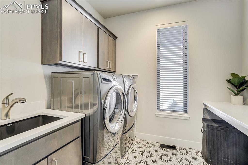 12284 Monarchos Lane Colorado Springs, CO 80921 - Photo 25 of 50 a utility room with a sink a washer and dryer
