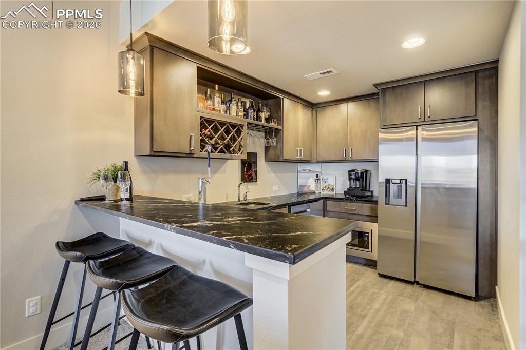 12284 Monarchos Lane Colorado Springs, CO 80921 - Photo 30 of 50 a kitchen with a refrigerator a sink and a stove