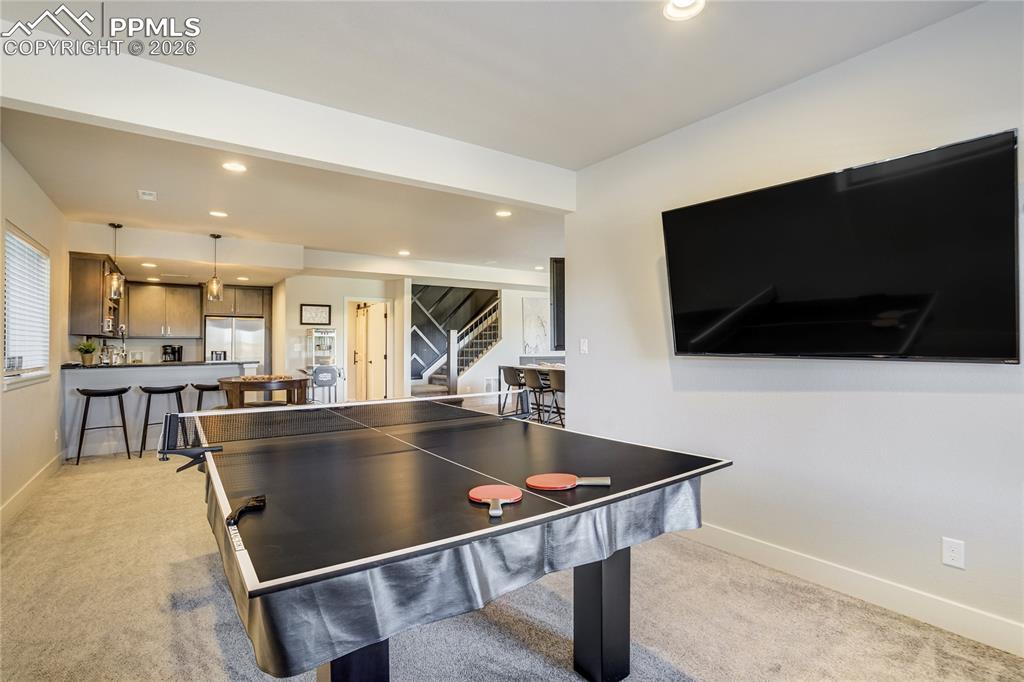 12284 Monarchos Lane Colorado Springs, CO 80921 - Photo 32 of 50 a living room with a flat screen tv and a table