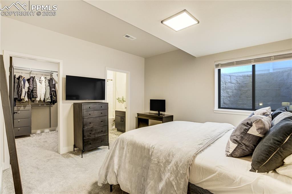 12284 Monarchos Lane Colorado Springs, CO 80921 - Photo 37 of 50 a bedroom with a bed and a flat screen tv