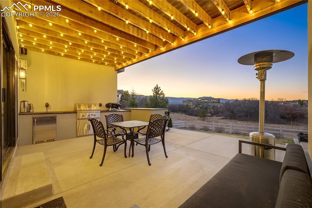 12284 Monarchos Lane Colorado Springs, CO 80921 - Photo 39 of 50 a view of a terrace with furniture and a yard