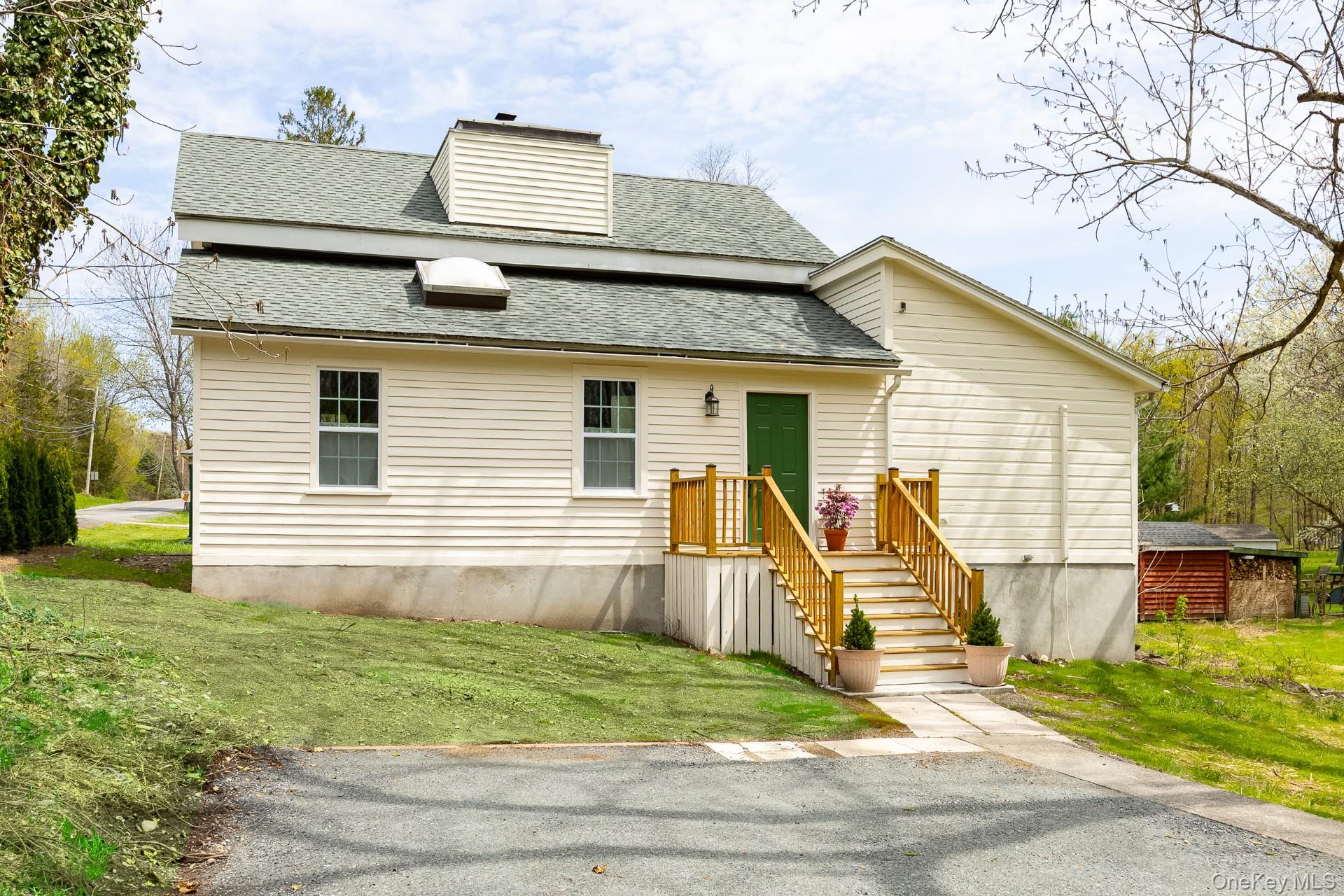 a view of a house with a yard and sitting area