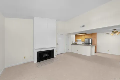 a view of empty room with a fireplace