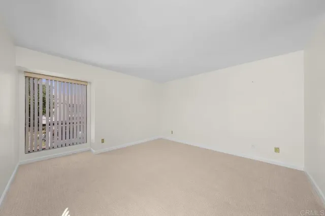 a utility room with stainless steel appliances a large window